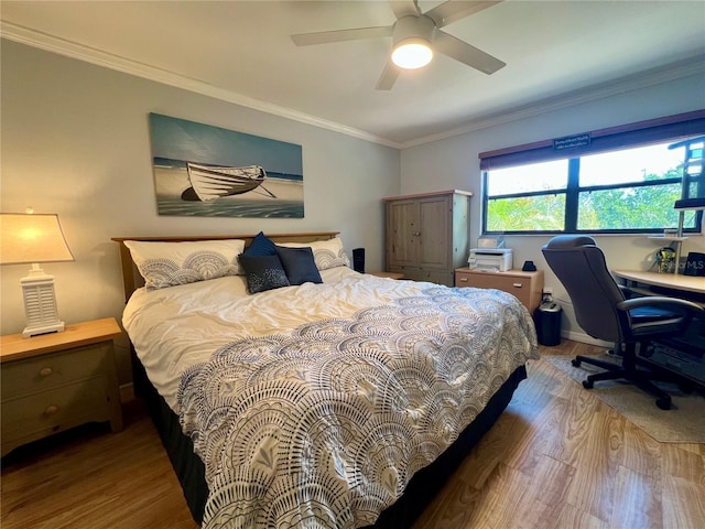 bedroom featuring crown molding, wood-type flooring, and ceiling fan