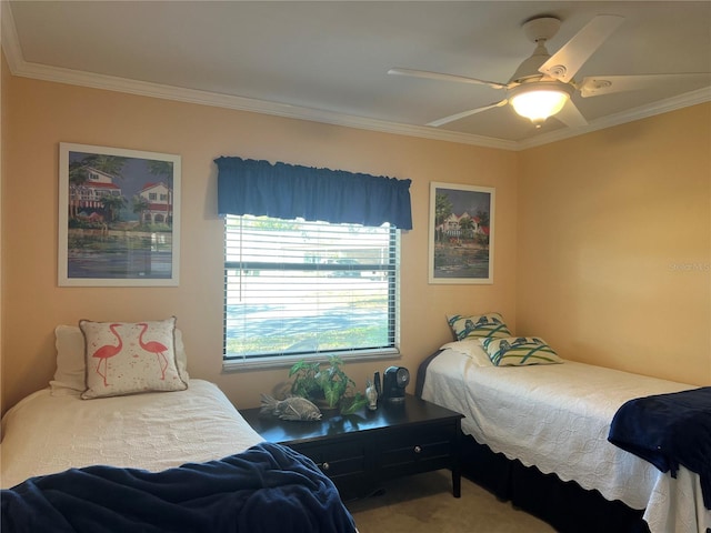 bedroom featuring crown molding, carpet flooring, and ceiling fan