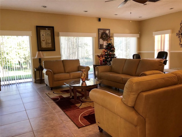 living room with plenty of natural light, light tile patterned floors, and ceiling fan