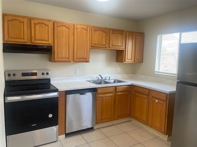 kitchen featuring appliances with stainless steel finishes, sink, and light tile patterned floors