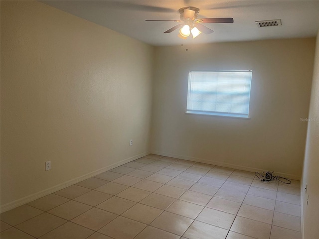 empty room featuring light tile patterned flooring and ceiling fan