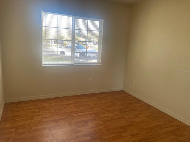 unfurnished room with wood-type flooring