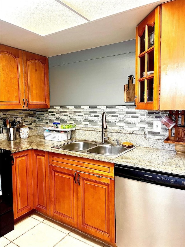 kitchen with sink, stainless steel dishwasher, backsplash, and light tile patterned floors