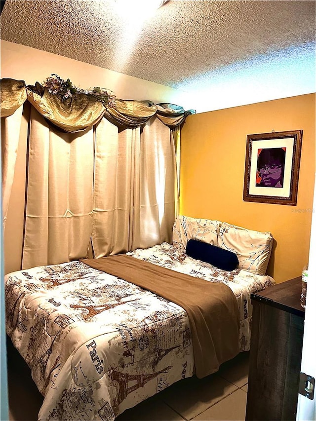 tiled bedroom featuring a textured ceiling