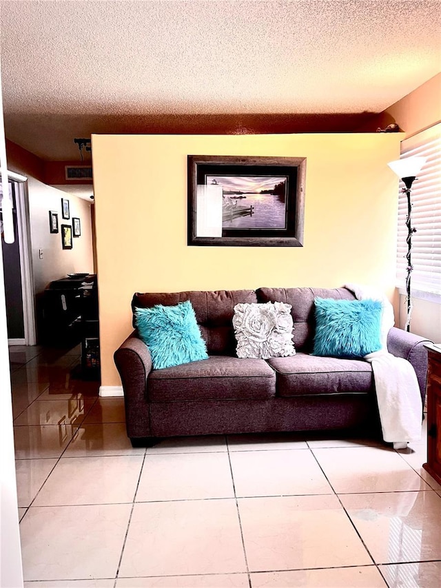 tiled living room with a textured ceiling