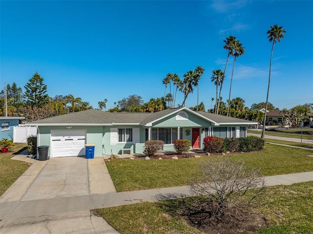 ranch-style home featuring a garage and a front lawn