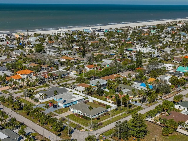 aerial view with a water view and a beach view