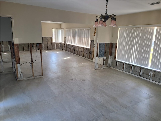 empty room featuring a chandelier