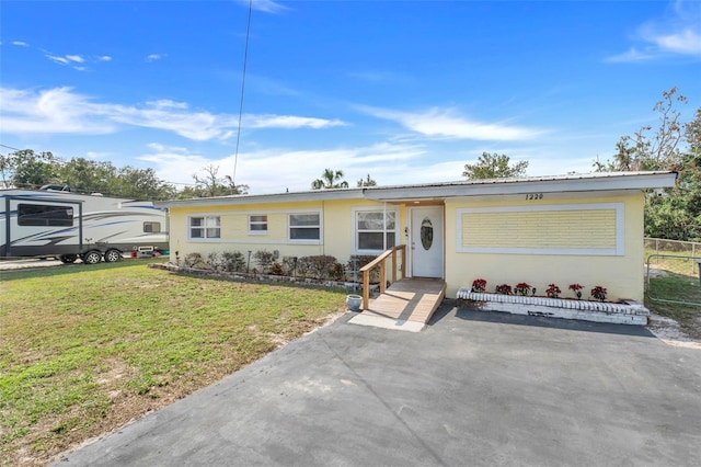 ranch-style home with a front yard