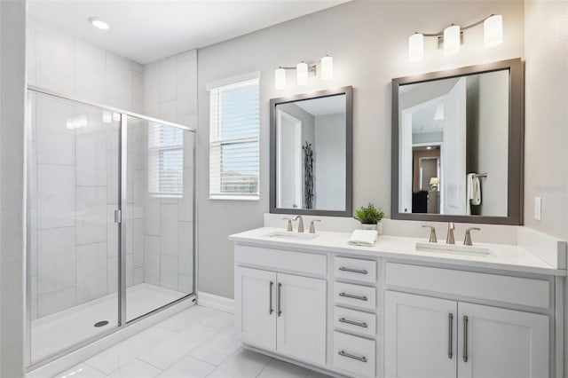 bathroom with a shower with door and vanity