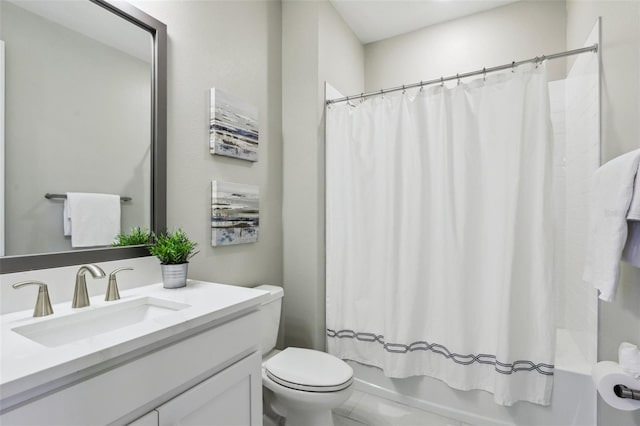 full bathroom featuring shower / bath combo, vanity, and toilet