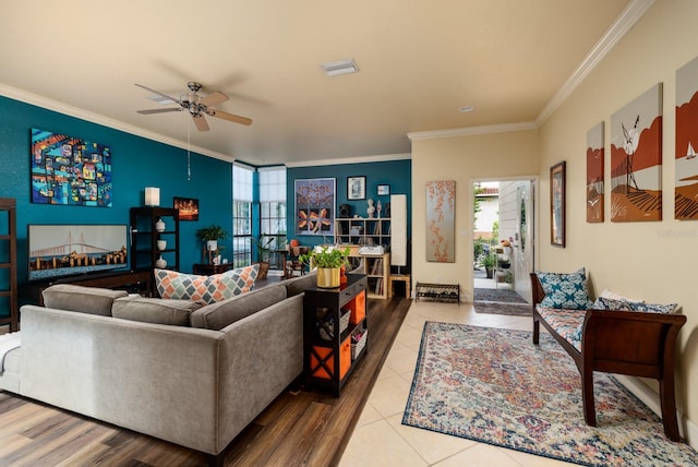 living room featuring ceiling fan, ornamental molding, and light tile patterned floors