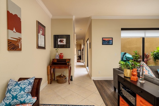 hallway featuring ornamental molding and light tile patterned floors