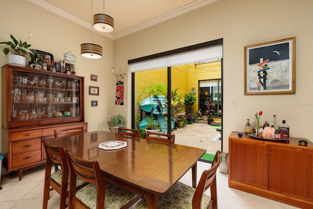 dining area featuring light tile patterned floors and ornamental molding