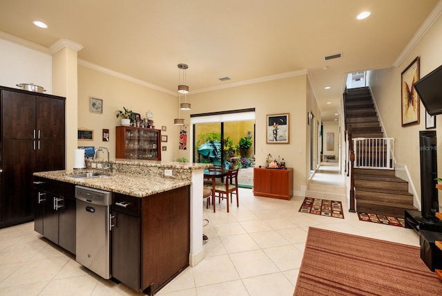 kitchen with light tile patterned flooring, sink, dark brown cabinets, stainless steel dishwasher, and pendant lighting