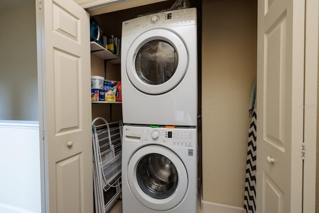 laundry room with stacked washing maching and dryer