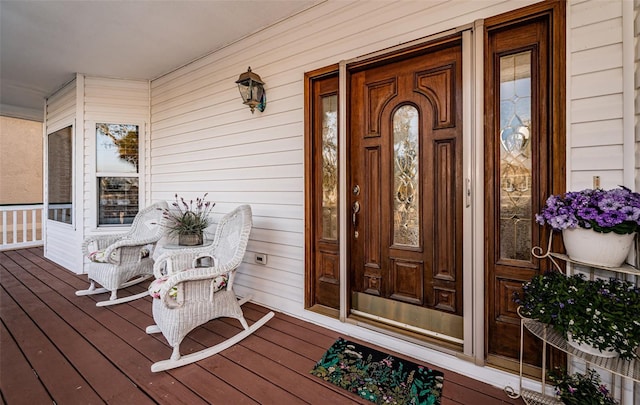 view of exterior entry with covered porch