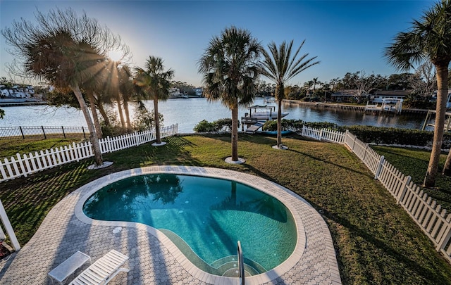 view of pool featuring a lawn and a water view