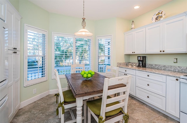 tiled dining room featuring a wealth of natural light