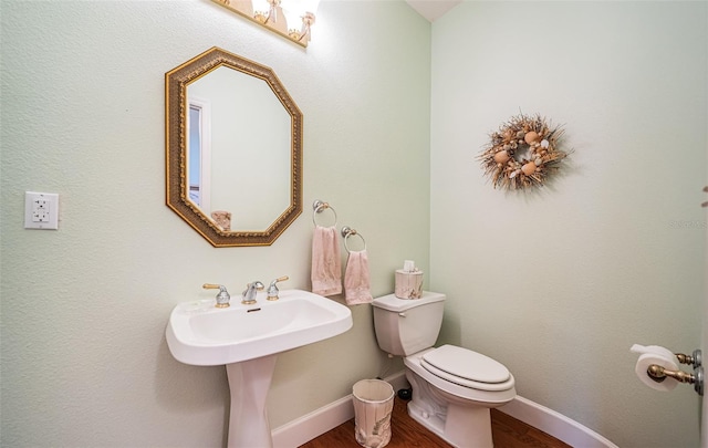 bathroom with sink, toilet, and hardwood / wood-style floors