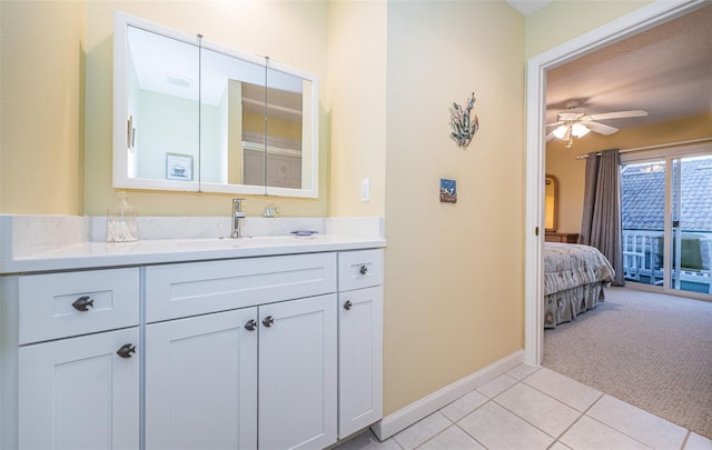 bathroom with tile patterned flooring, vanity, and ceiling fan