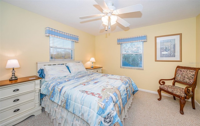 carpeted bedroom featuring ceiling fan and multiple windows