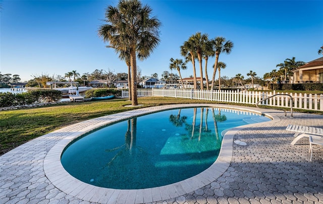 view of pool featuring a lawn