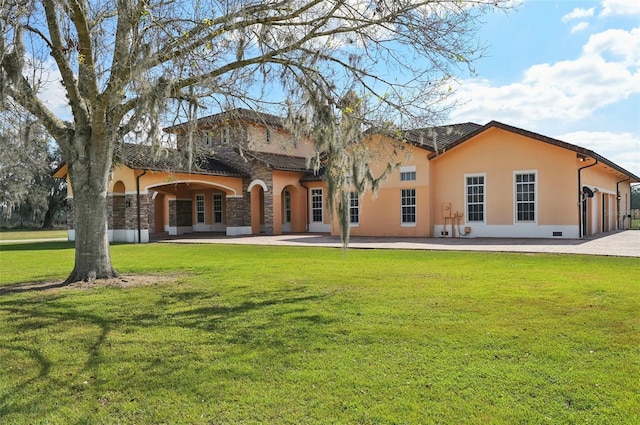 rear view of property featuring a yard