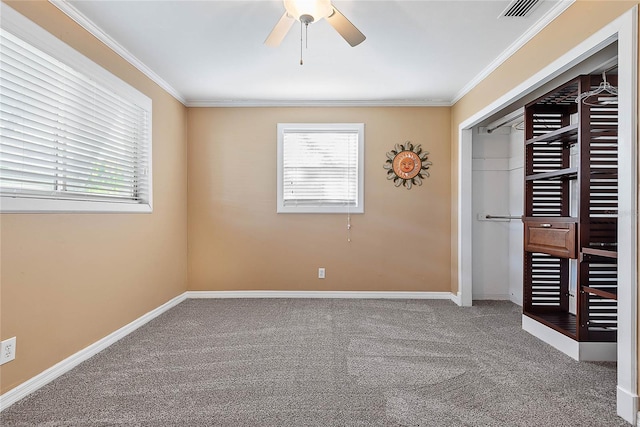 unfurnished bedroom with multiple windows, crown molding, and carpet floors