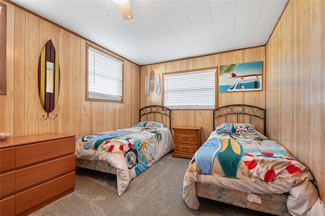 carpeted bedroom with wood walls