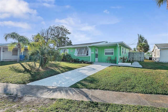 ranch-style home with a front lawn and central air condition unit