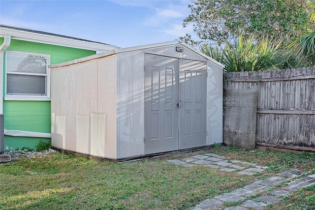 view of outbuilding with a lawn