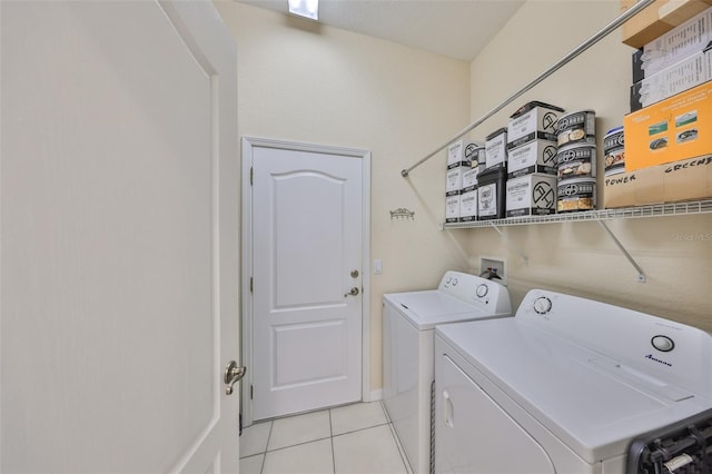 washroom featuring washing machine and dryer and light tile patterned flooring