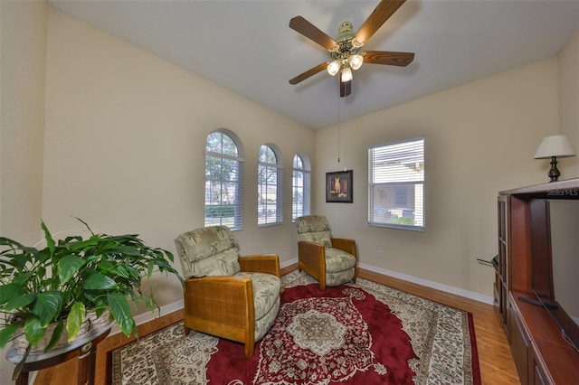 sitting room featuring lofted ceiling, hardwood / wood-style floors, and ceiling fan