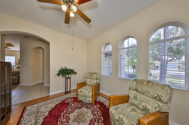 sitting room with lofted ceiling, a healthy amount of sunlight, ceiling fan, and light hardwood / wood-style floors