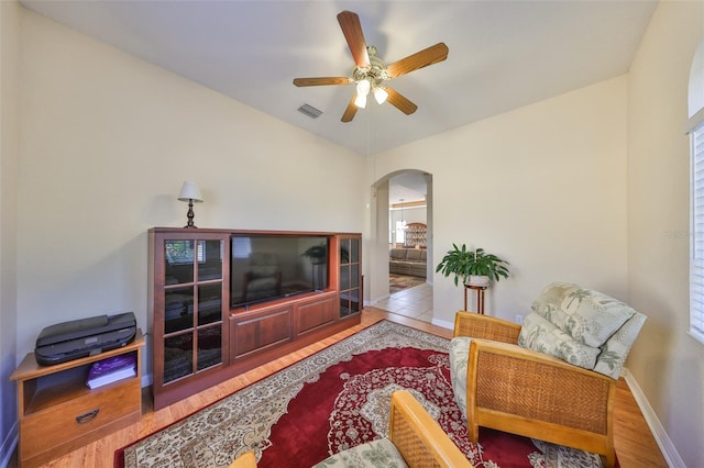 living room featuring light hardwood / wood-style floors and ceiling fan