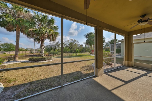 unfurnished sunroom featuring ceiling fan