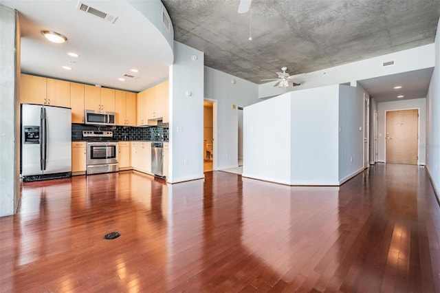 kitchen with light brown cabinetry, dark hardwood / wood-style floors, ceiling fan, and appliances with stainless steel finishes