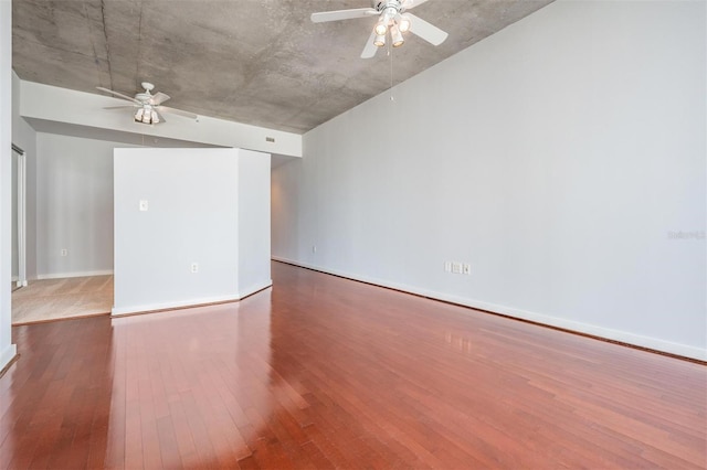 empty room featuring wood-type flooring and ceiling fan