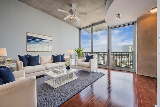 living room featuring dark wood-type flooring, expansive windows, and ceiling fan