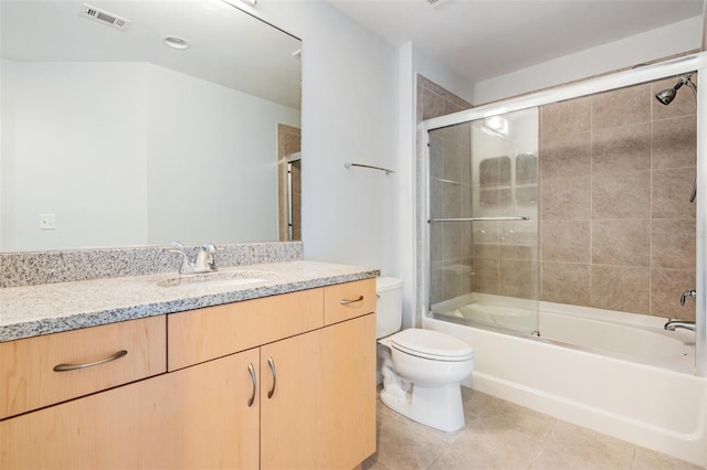 full bathroom with tile patterned floors, toilet, combined bath / shower with glass door, and vanity