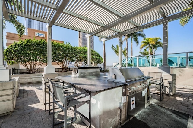 view of patio / terrace featuring exterior bar, area for grilling, and a pergola