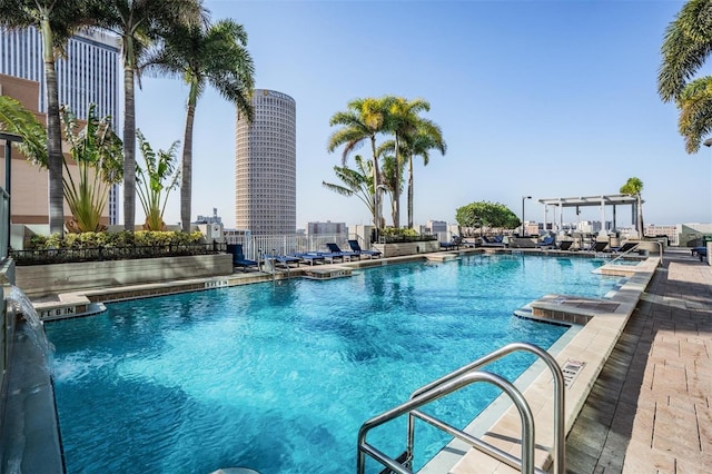 view of swimming pool with pool water feature