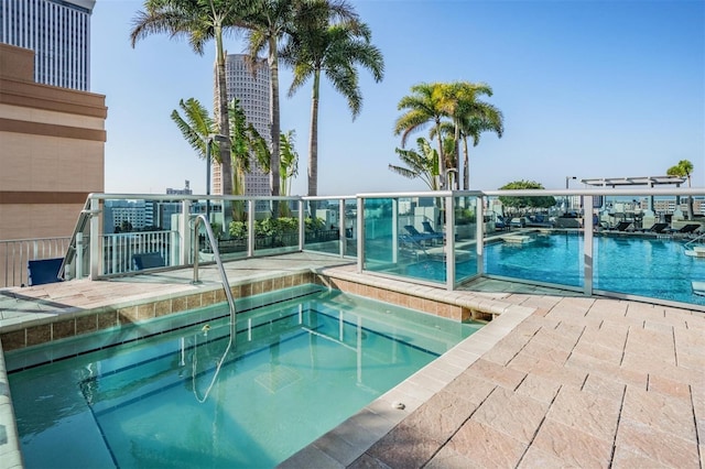 view of pool with a hot tub