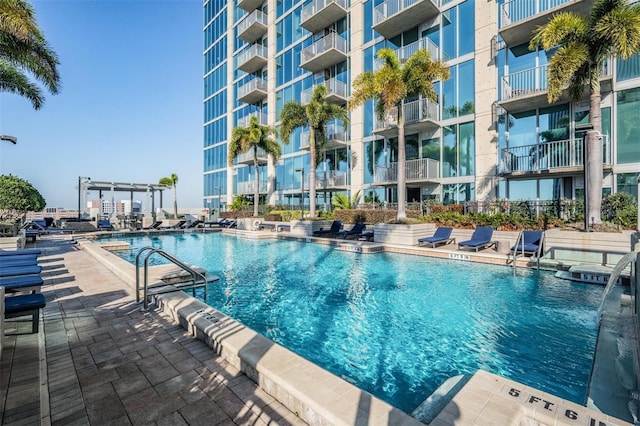 view of swimming pool featuring a pergola and a patio