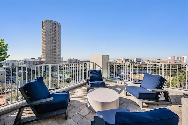 view of patio with a balcony and a water view