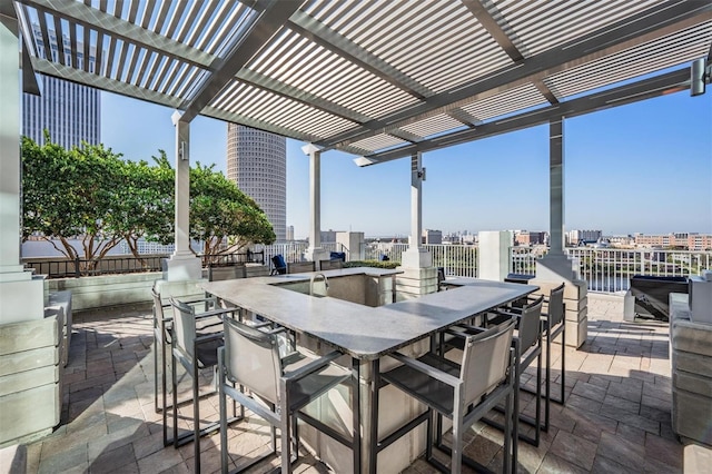 view of patio with exterior bar and a pergola