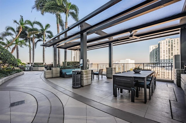 patio terrace at dusk with a pergola and ceiling fan