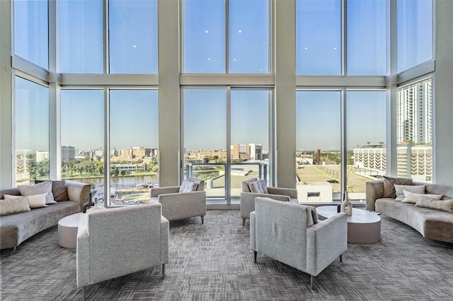 sunroom featuring a water view