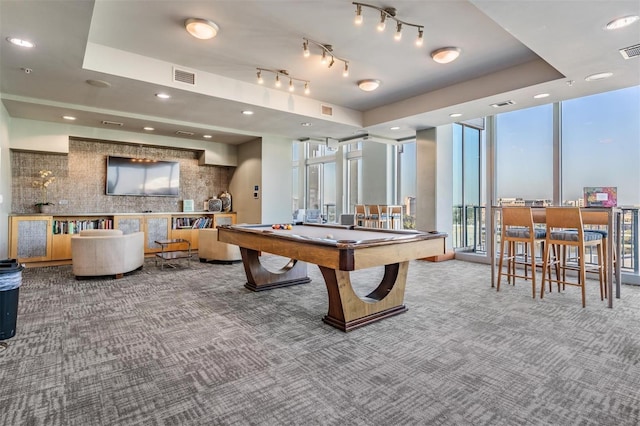 recreation room with carpet flooring, expansive windows, pool table, a tray ceiling, and track lighting